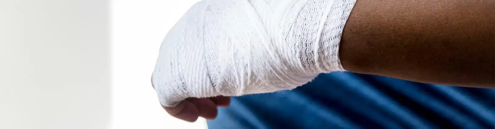 mans hand wrapped in banages