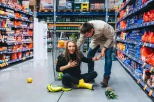 A woman laughing about a slip and fall in a store but she could need a slip and fall lawyer
