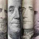 close up of the faces on american paper bills.