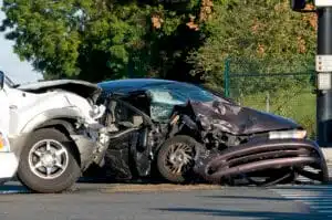 Aftermath of a two vehicle crash with a car that has been hit in the side with heavy damage in need of an elgin accident lawyer.