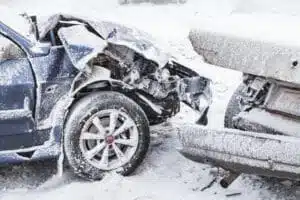 Crashed cars right after an accident on winter road with snow who need a car accident lawyer